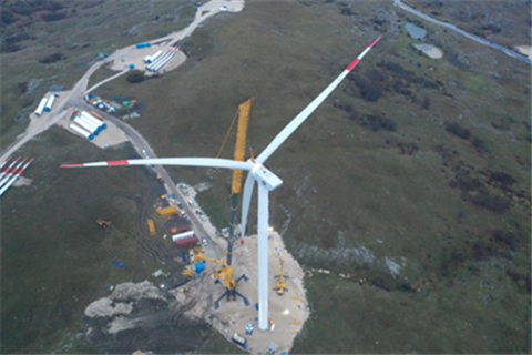 aerial view of yellow XCMG crane erecting a wind turbine
