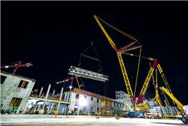 Buckner in the USA using one of its two Liebherr LR 13000 crawler cranes lifting 51 metre steel trusses at night