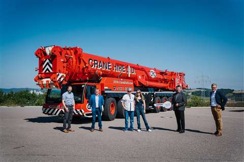 O'Leary family and Liebherr people standing in front of their new red 8 axle crane