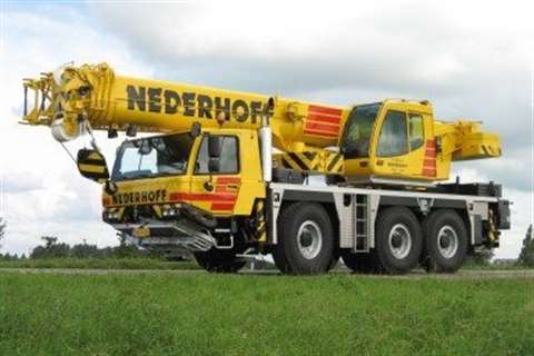 Front three quarter view of three axle AT crane in Nederhoff yellow and red livery