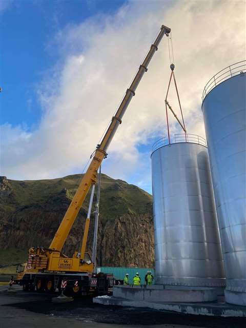 One of the four storage tanks being placed into position